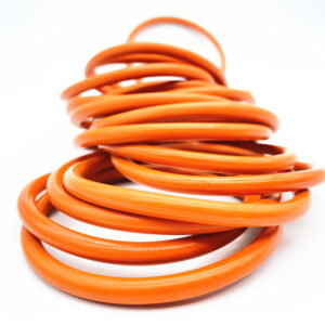 Stacked orange sealing rings on a white background