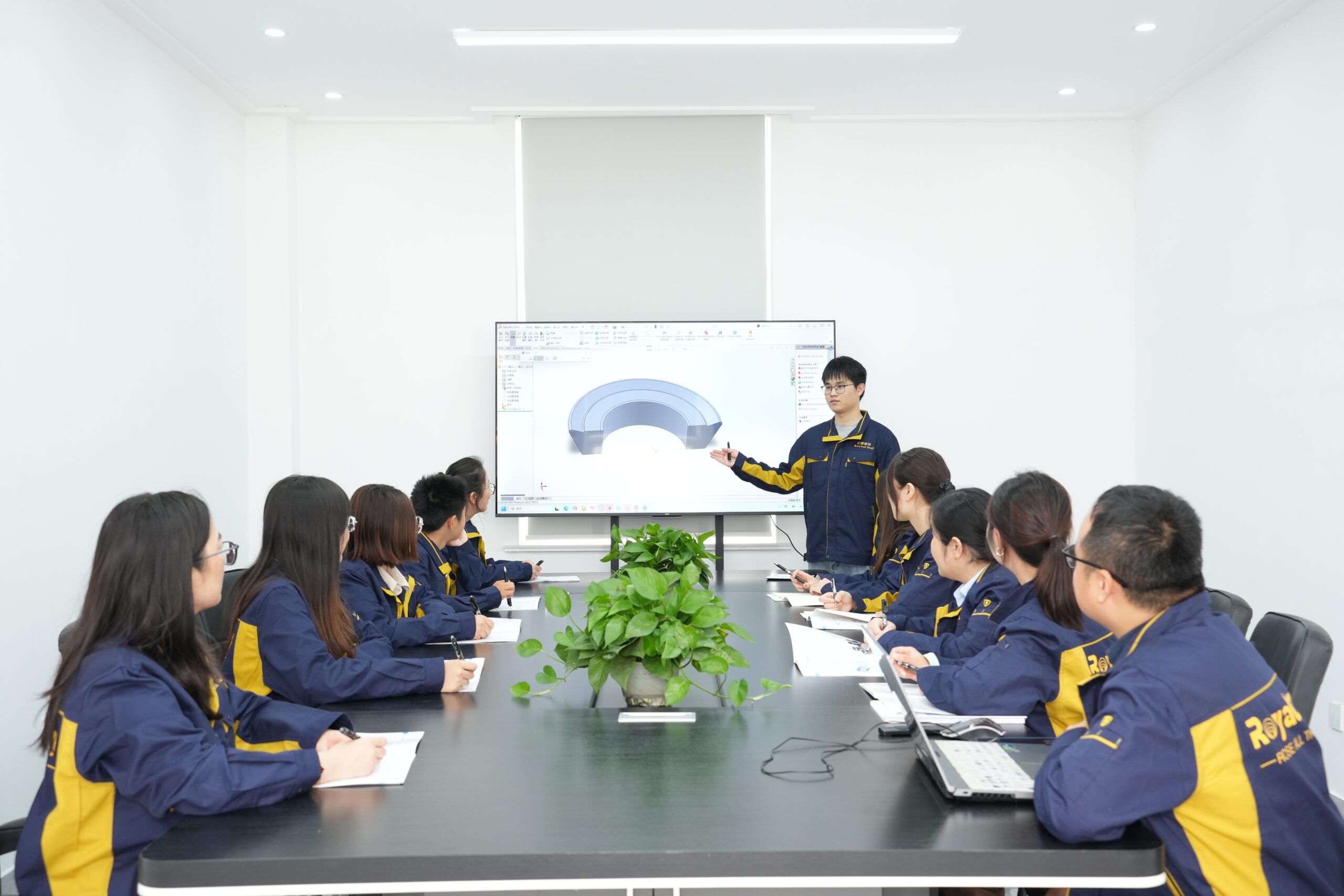 Team of engineers collaborating over blueprints