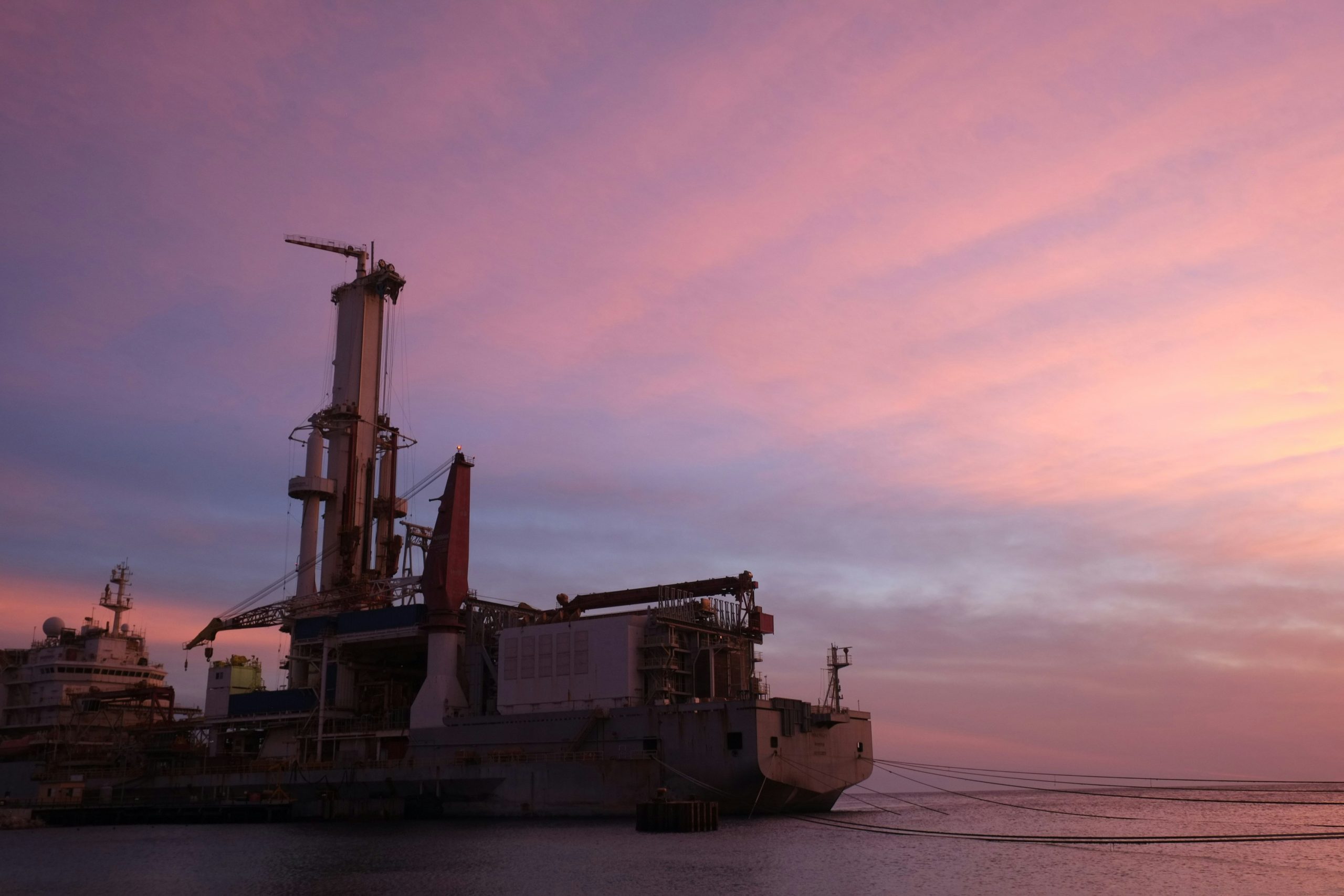 Expansive view of an offshore oil rig at sunset